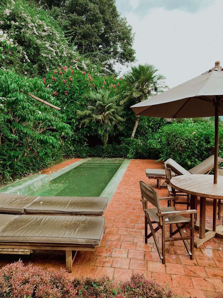 Peaceful tropical garden with pool and furniture in Medellín, Colombia, perfect for relaxation.